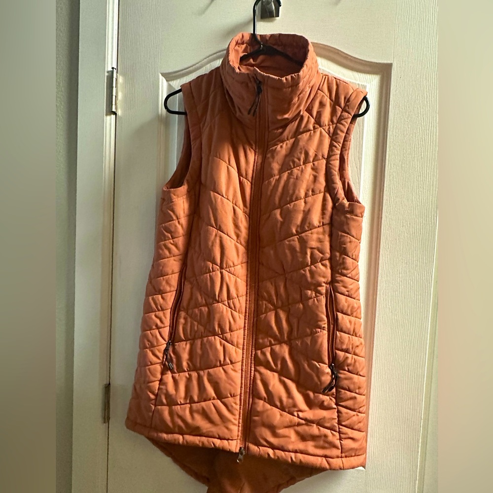Long vest, color is more of a light rust.  Really cute with legging and boots!